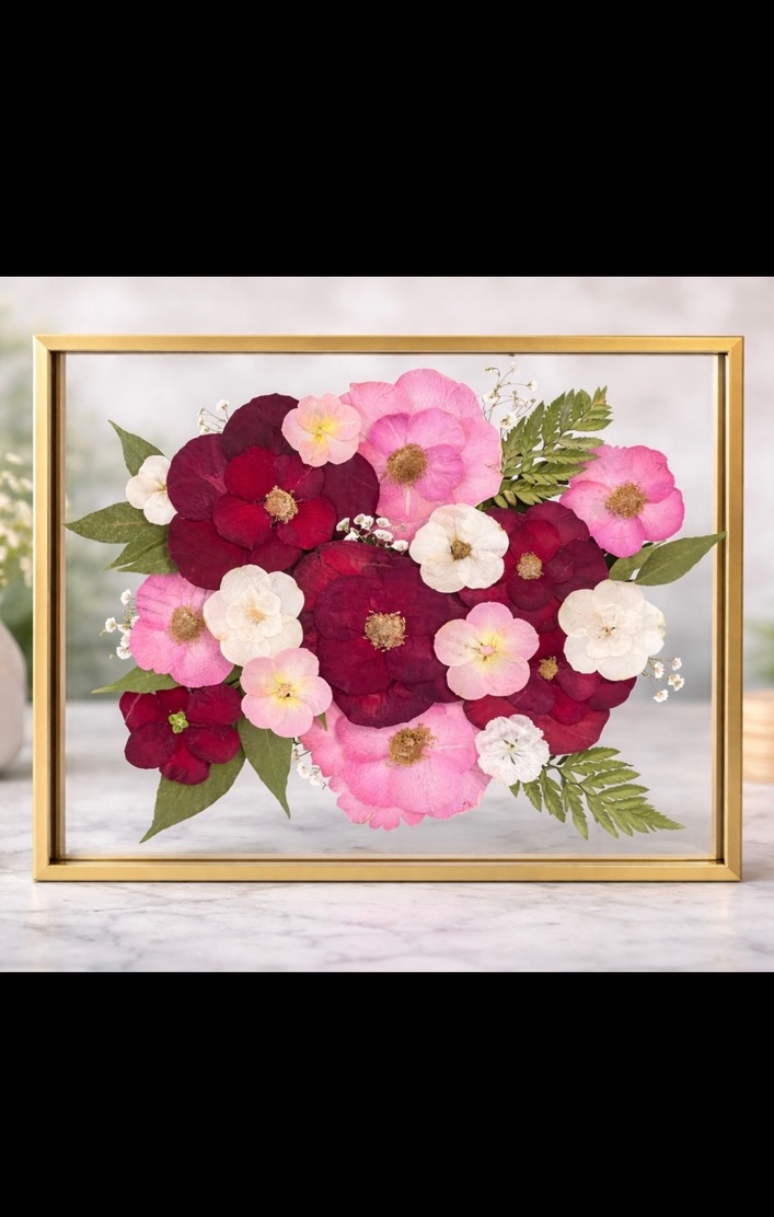 Deep burgundy and pink pressed flower bouquet in a gold frame